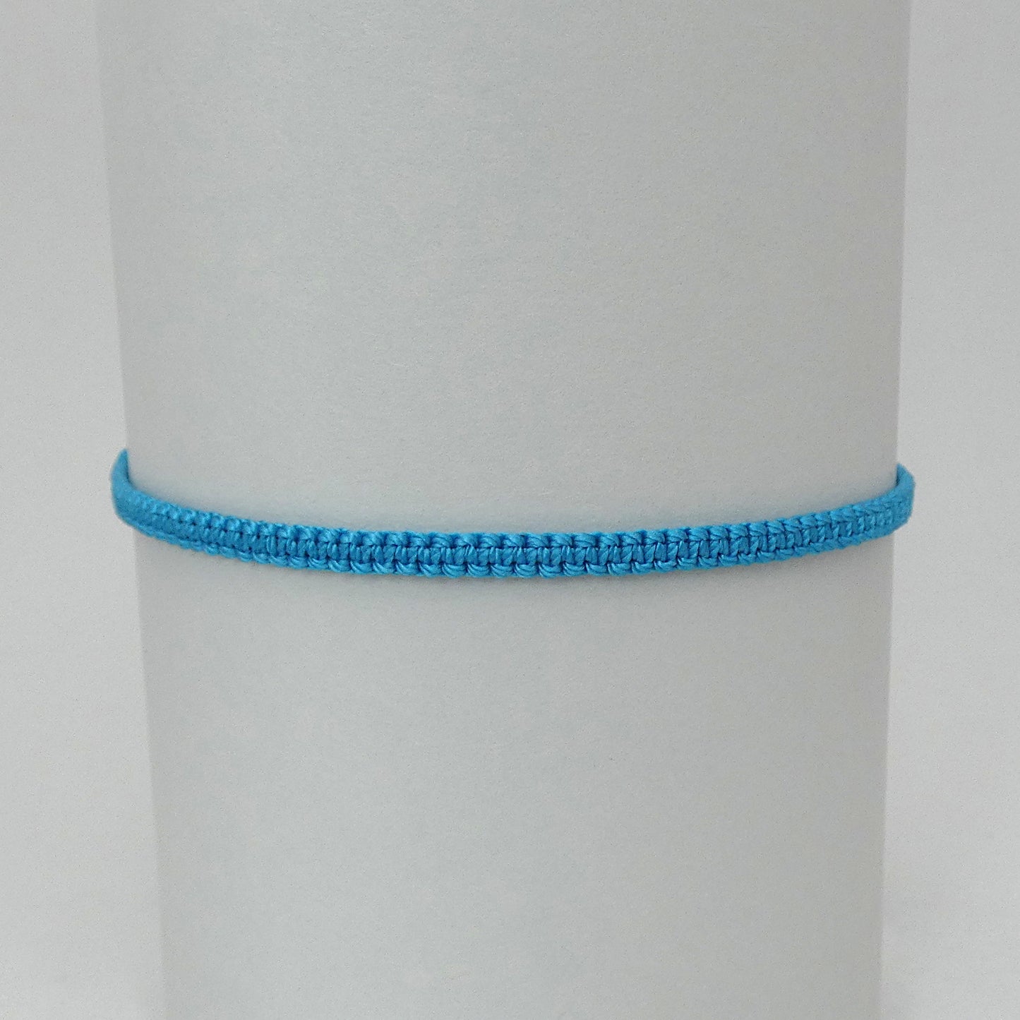 7” adjustable Bermuda blue macramé bracelet for adults with silver plated bead ends.