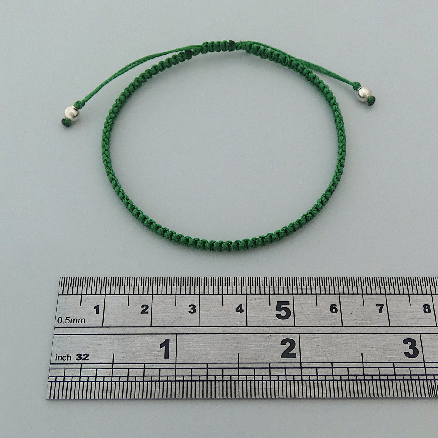 7” adjustable Christmas green macramé bracelet for adults with silver plated bead ends.