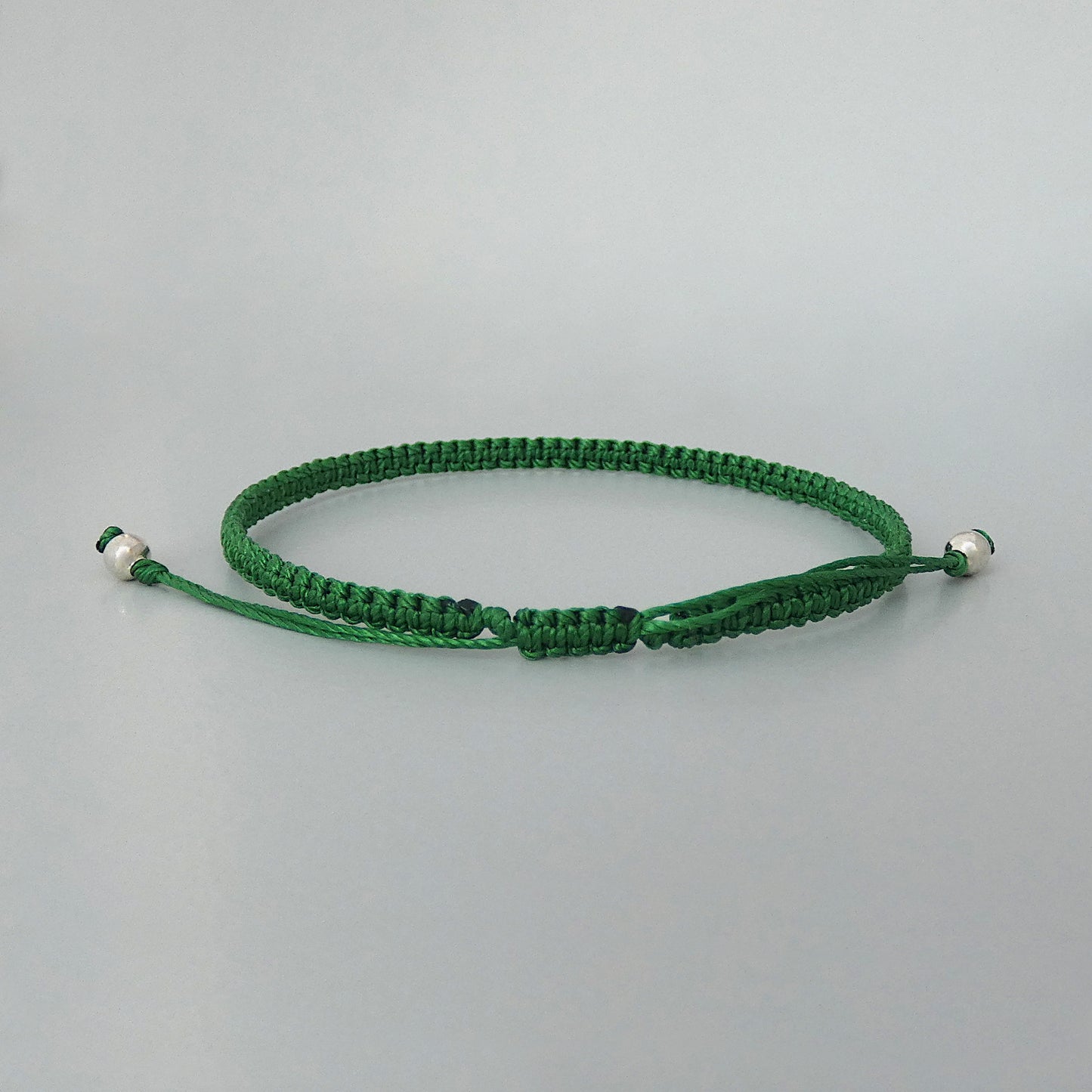 7” adjustable Christmas green macramé bracelet for adults with silver plated bead ends.