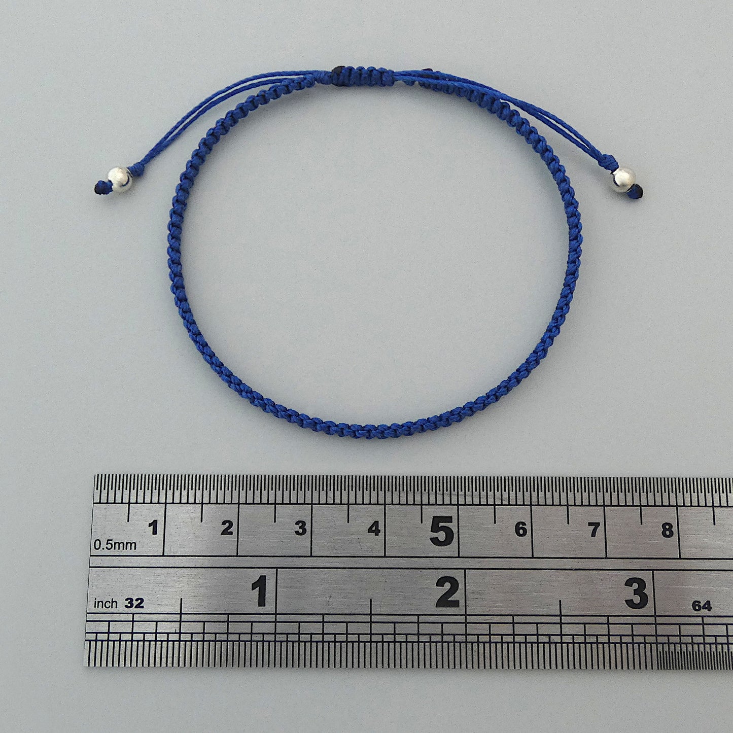 7” adjustable Royal blue coloured macramé bracelet for adults with silver plated bead ends.