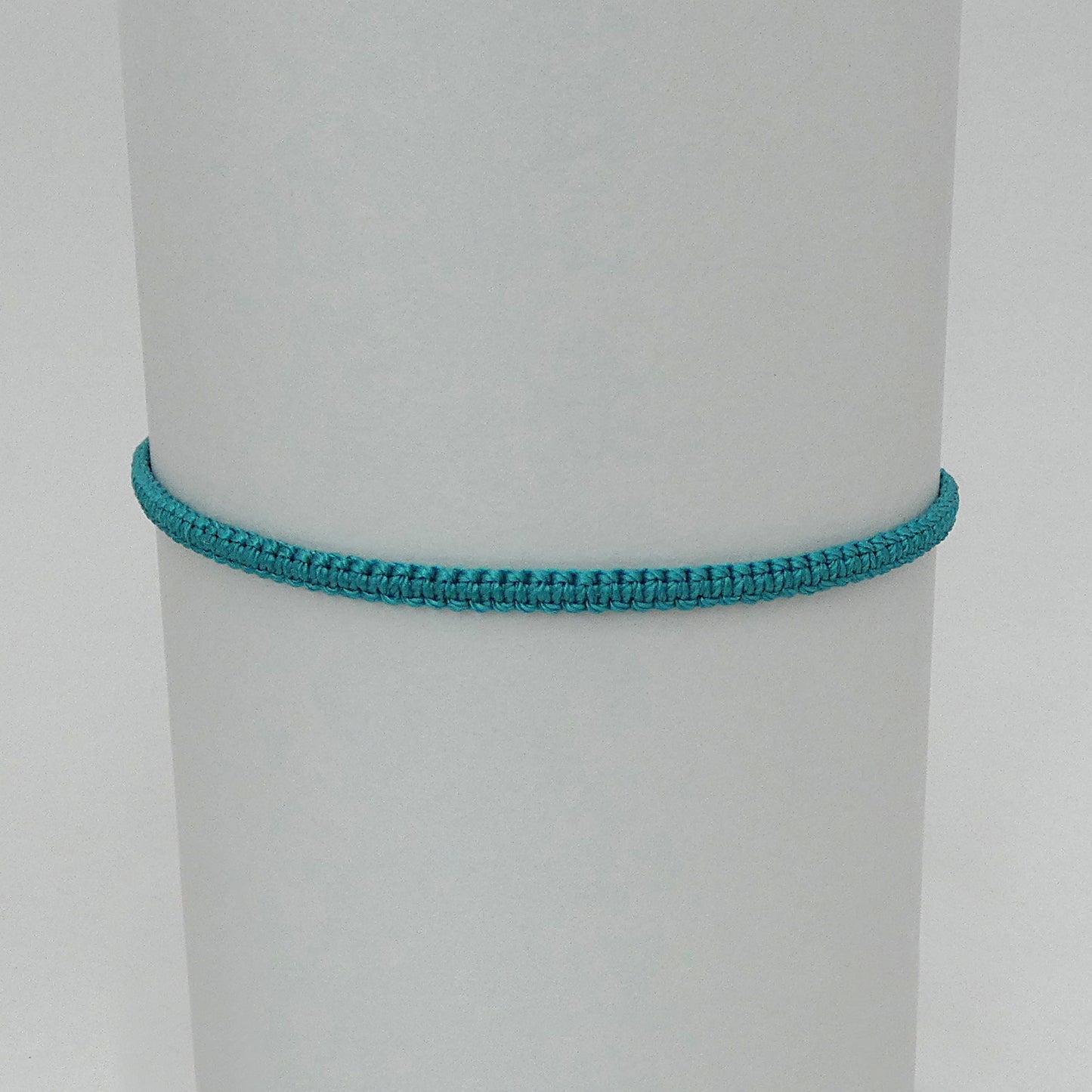 7” adjustable teal coloured macramé bracelet for adults with silver plated bead ends.