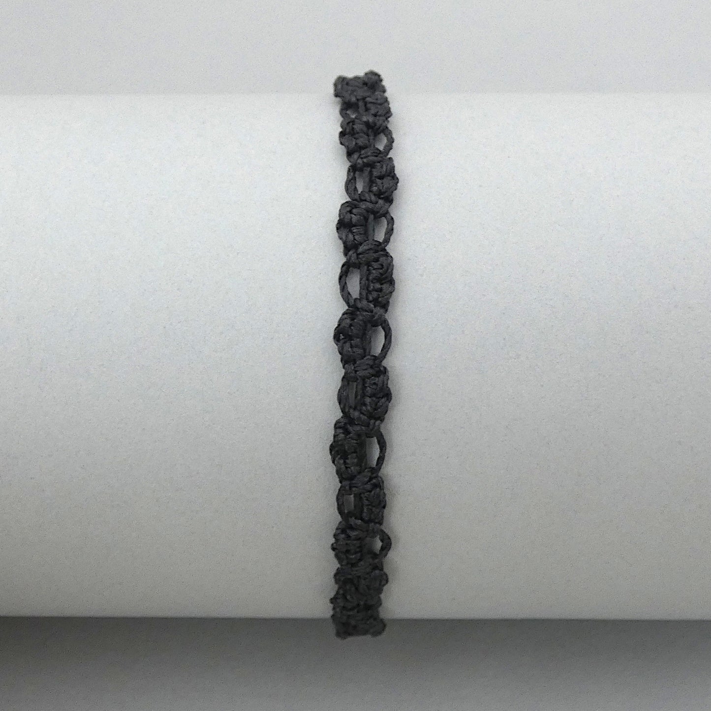 Black macramé bracelet tied with an intricate lace effect with silver plated clasp and optional 1” extender chain.