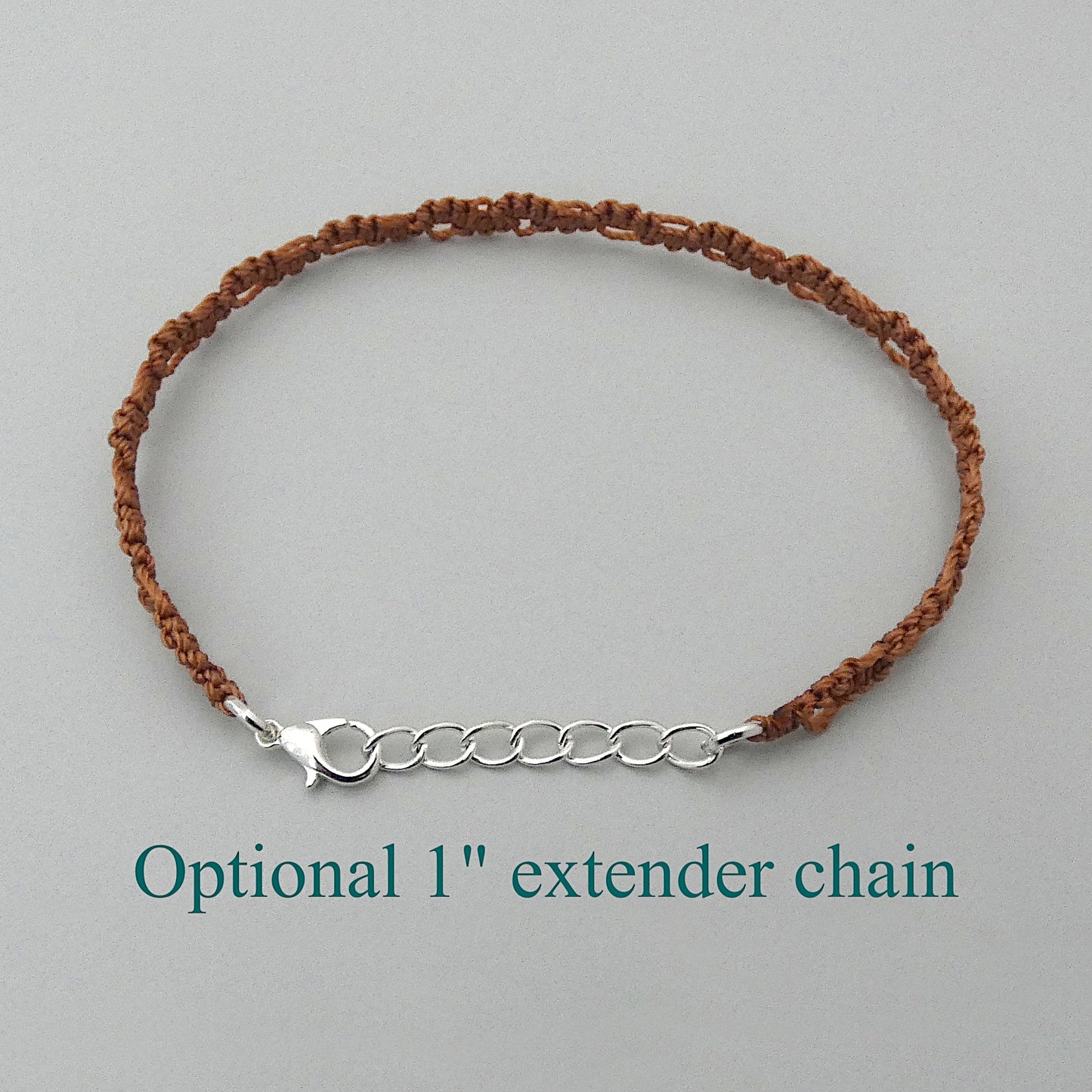 Copper coloured macramé bracelet tied with an intricate lace effect with silver plated clasp and optional 1” extender chain.