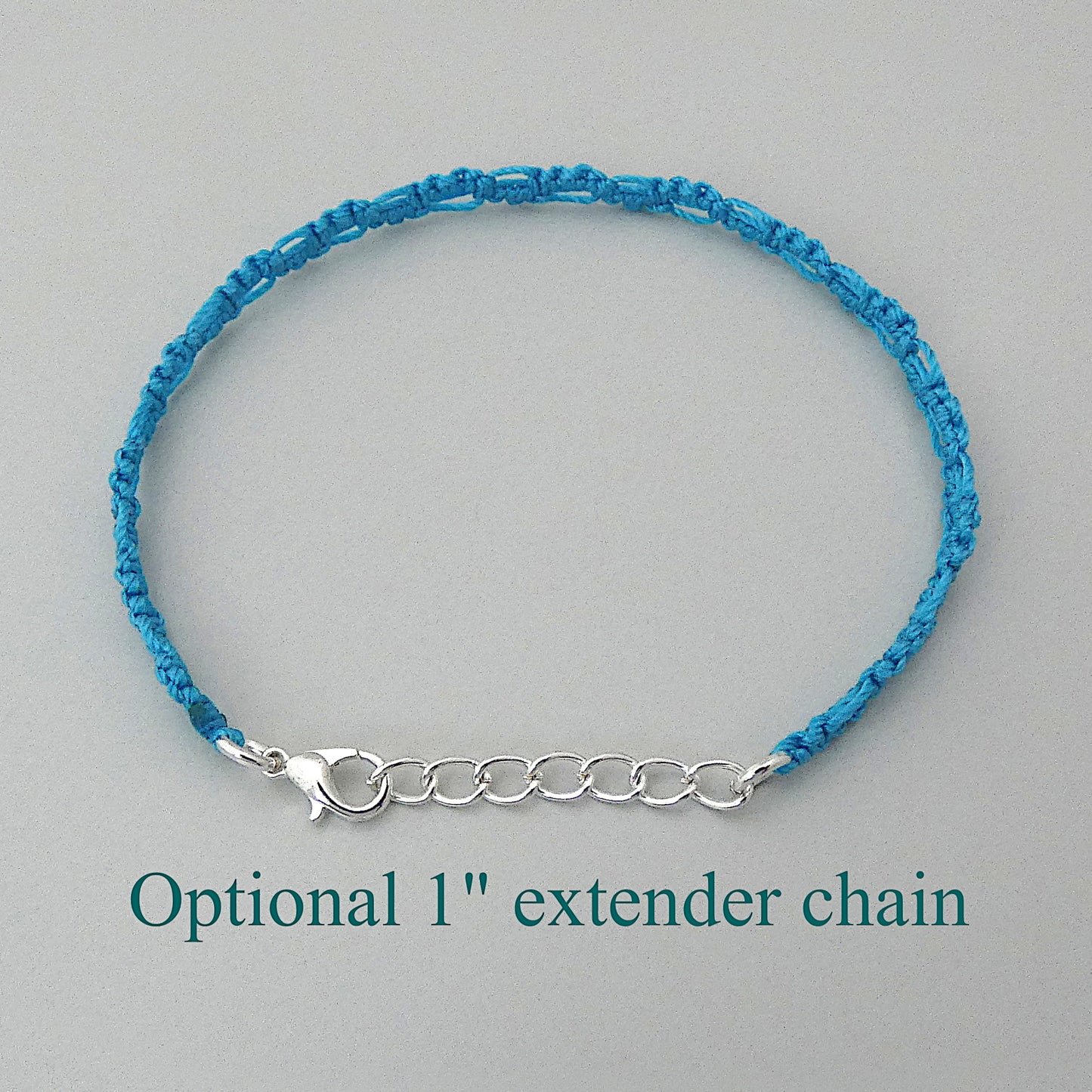 Bermuda blue macramé bracelet tied with an intricate lace effect with silver plated clasp and optional 1” extender chain.