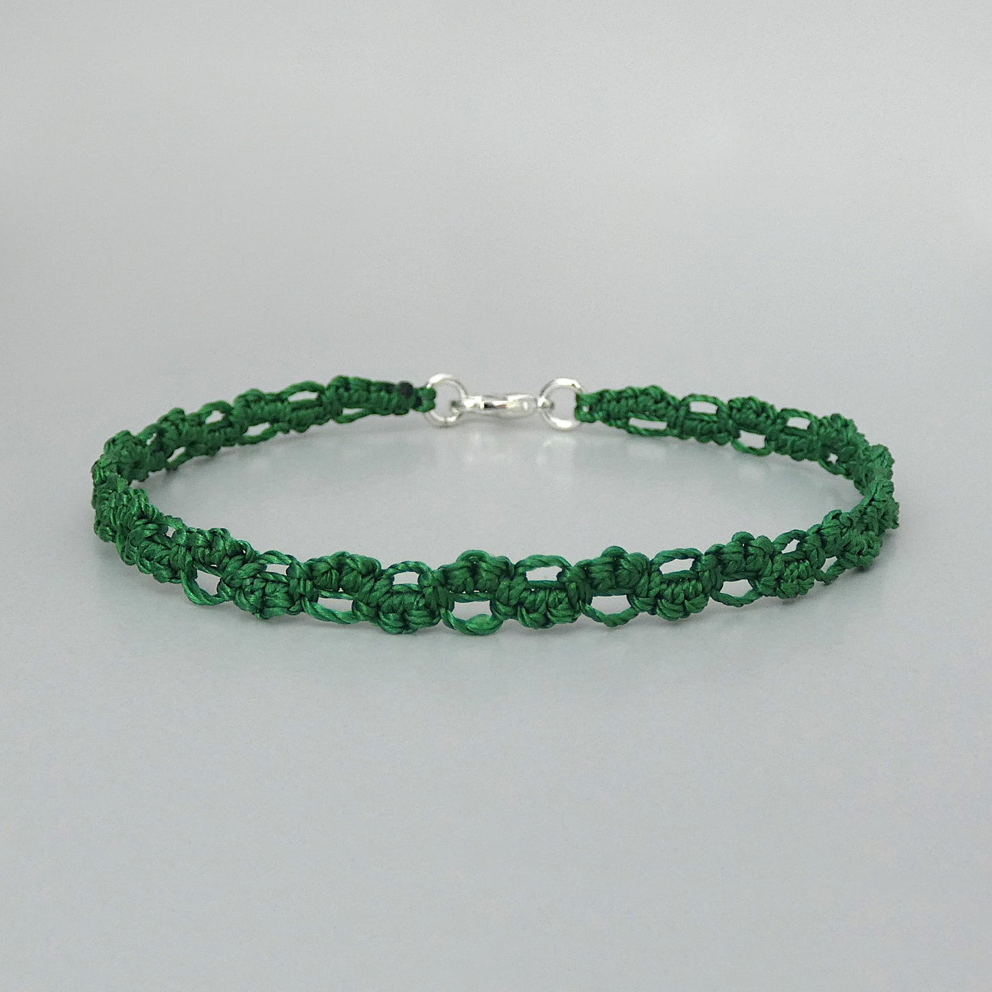 Christmas green macramé bracelet tied with an intricate lace effect with silver plated clasp and optional 1” extender chain.