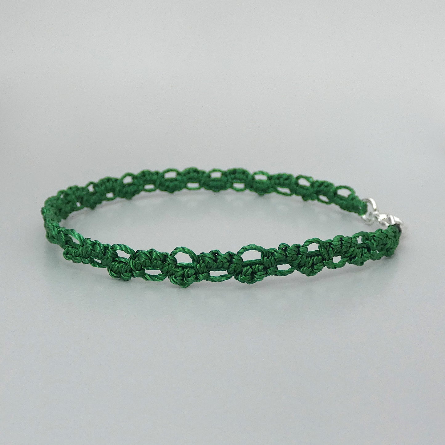 Christmas green macramé bracelet tied with an intricate lace effect with silver plated clasp and optional 1” extender chain.