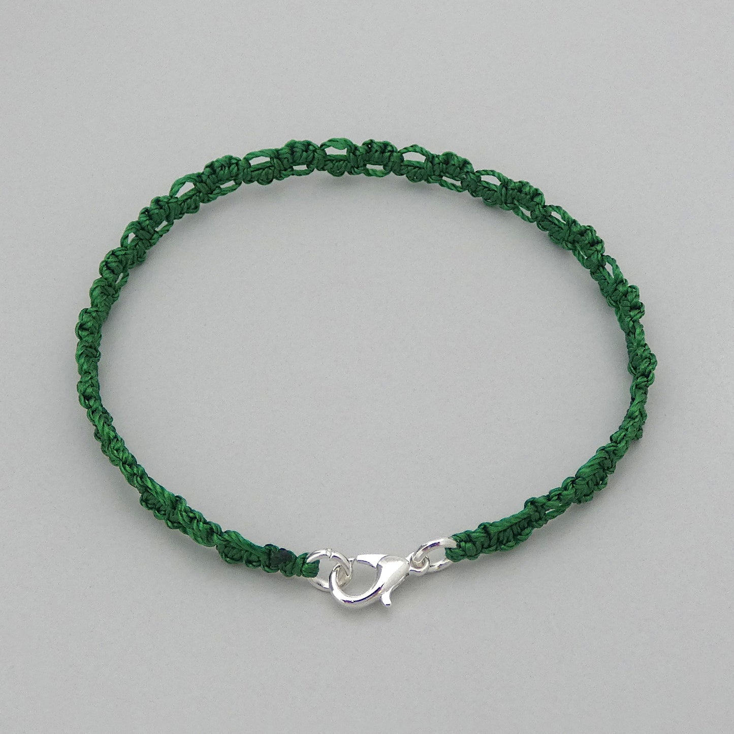 Christmas green macramé bracelet tied with an intricate lace effect with silver plated clasp and optional 1” extender chain.