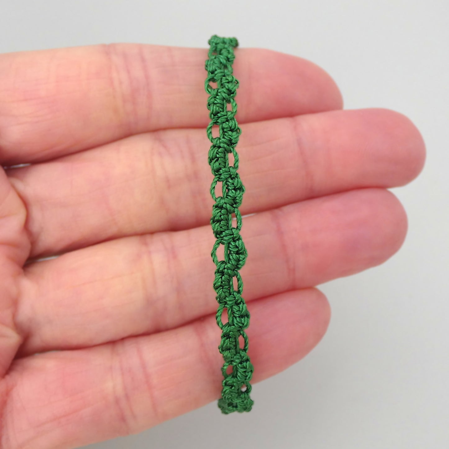 Christmas green macramé bracelet tied with an intricate lace effect with silver plated clasp and optional 1” extender chain.