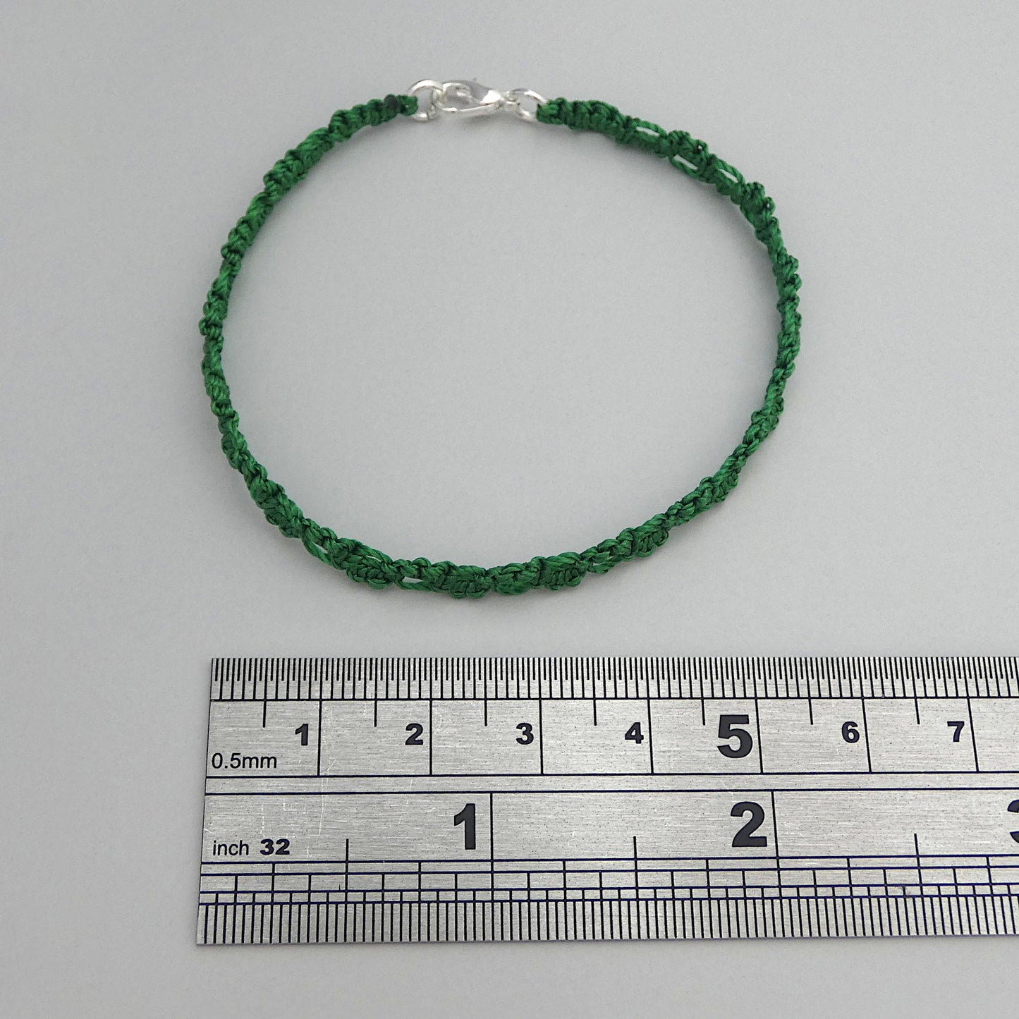 Christmas green macramé bracelet tied with an intricate lace effect with silver plated clasp and optional 1” extender chain.