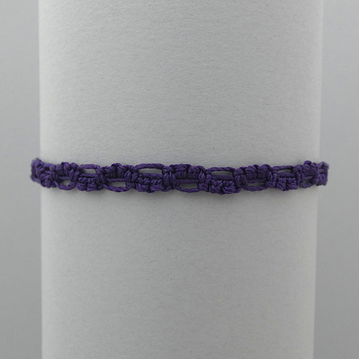 Dark purple macramé bracelet tied with an intricate lace effect with silver plated clasp and optional 1” extender chain.