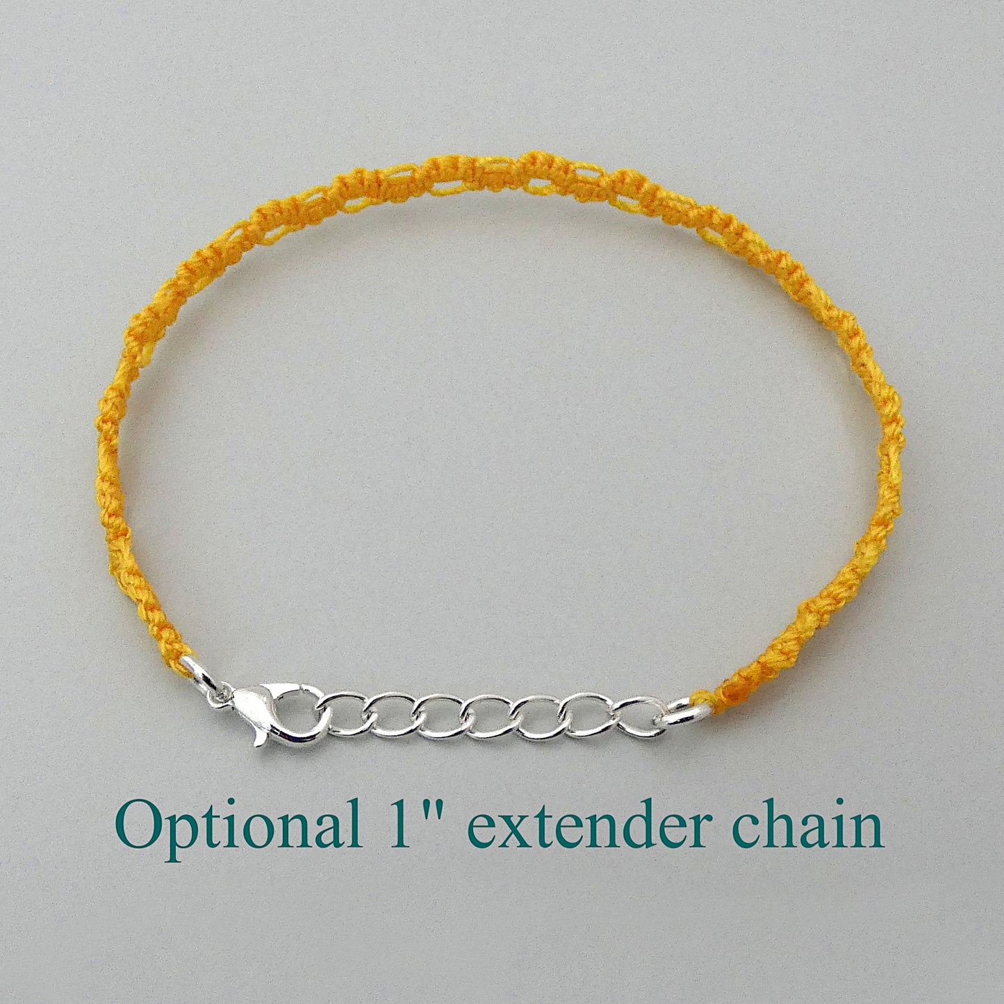 Golden yellow macramé bracelet tied with an intricate lace effect with silver plated clasp and optional 1” extender chain.