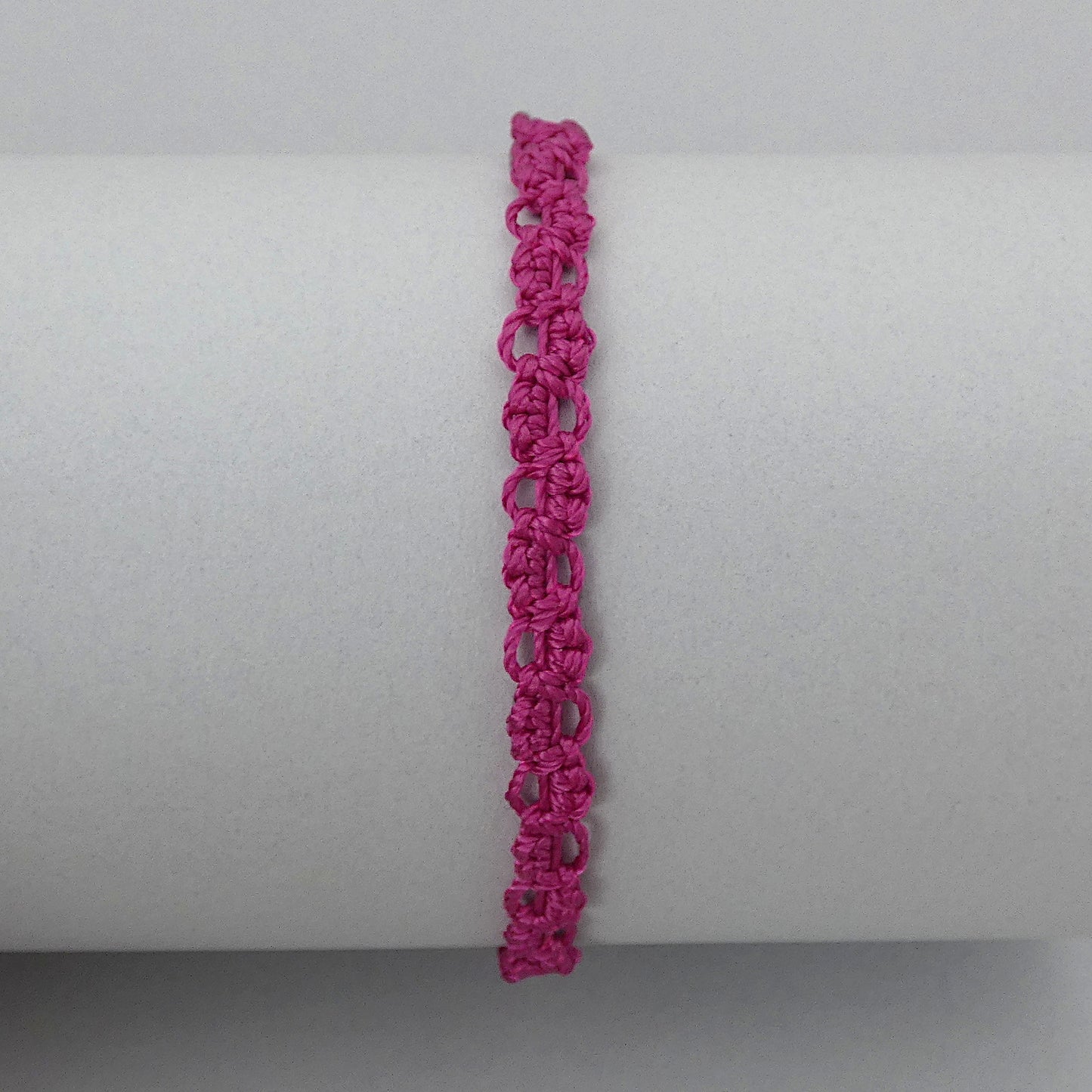Magenta purple macramé bracelet tied with an intricate lace effect with silver plated clasp and optional 1” extender chain.
