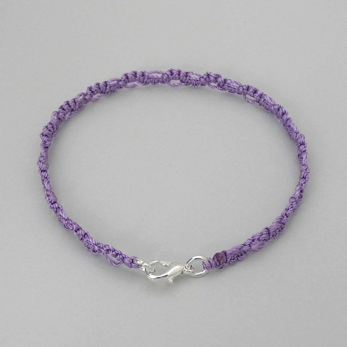 Orchid purple macramé bracelet tied with an intricate lace effect with silver plated clasp and optional 1” extender chain.