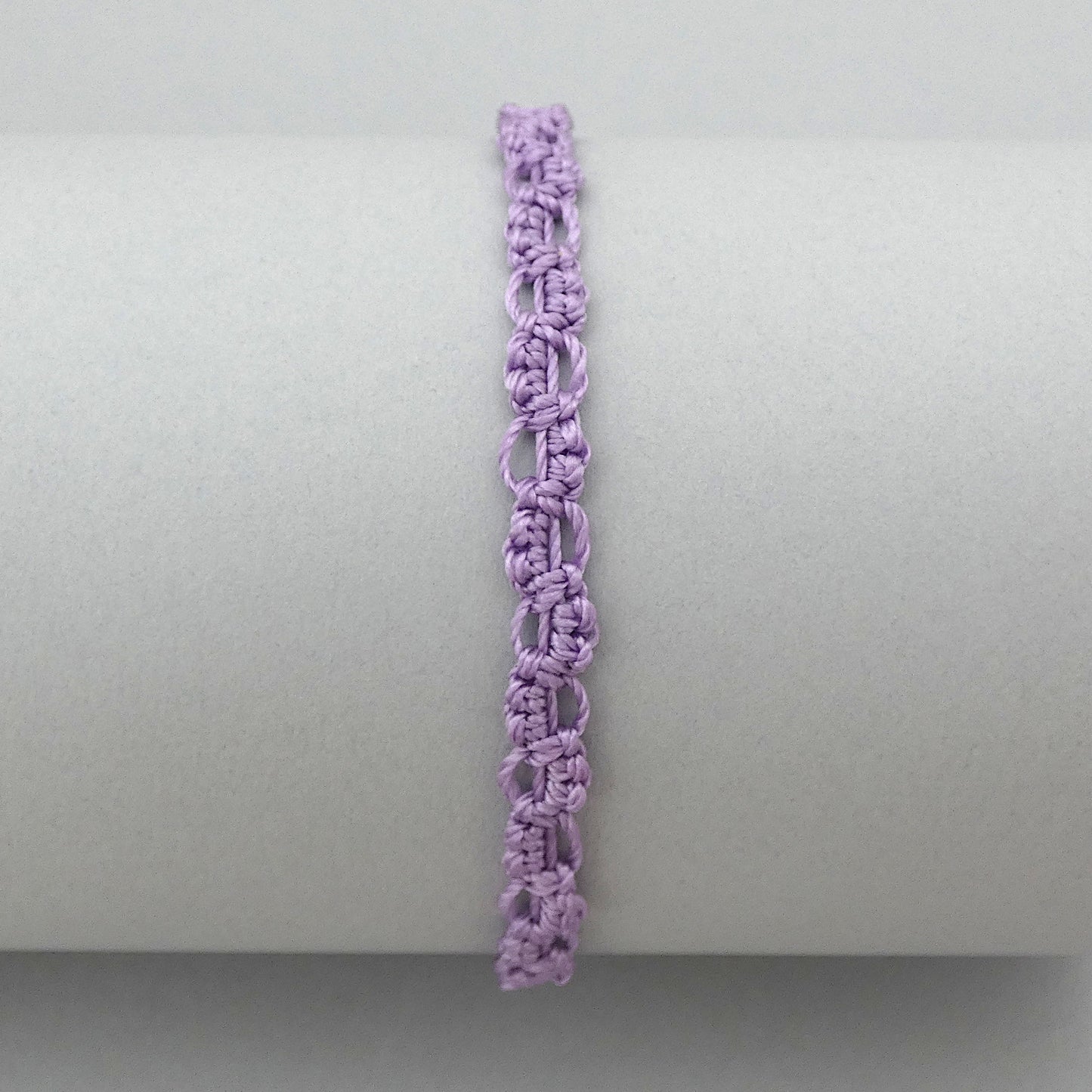 Orchid purple macramé bracelet tied with an intricate lace effect with silver plated clasp and optional 1” extender chain.