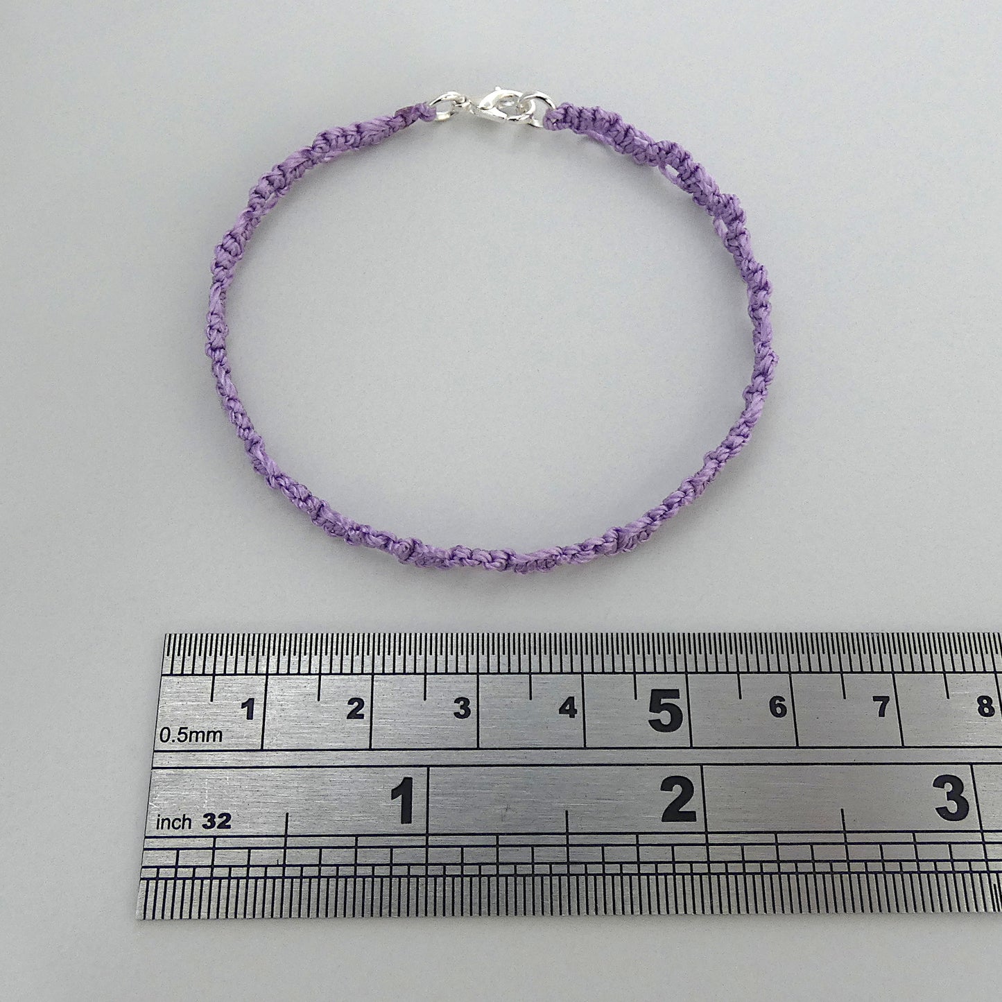Orchid purple macramé bracelet tied with an intricate lace effect with silver plated clasp and optional 1” extender chain.