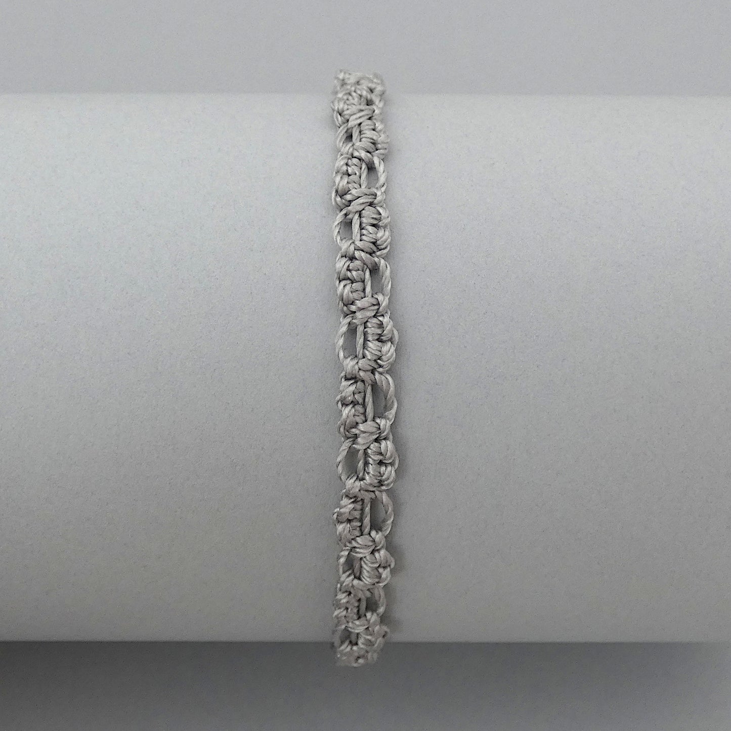 Silver grey macramé bracelet tied with an intricate lace effect with silver plated clasp and optional 1” extender chain.