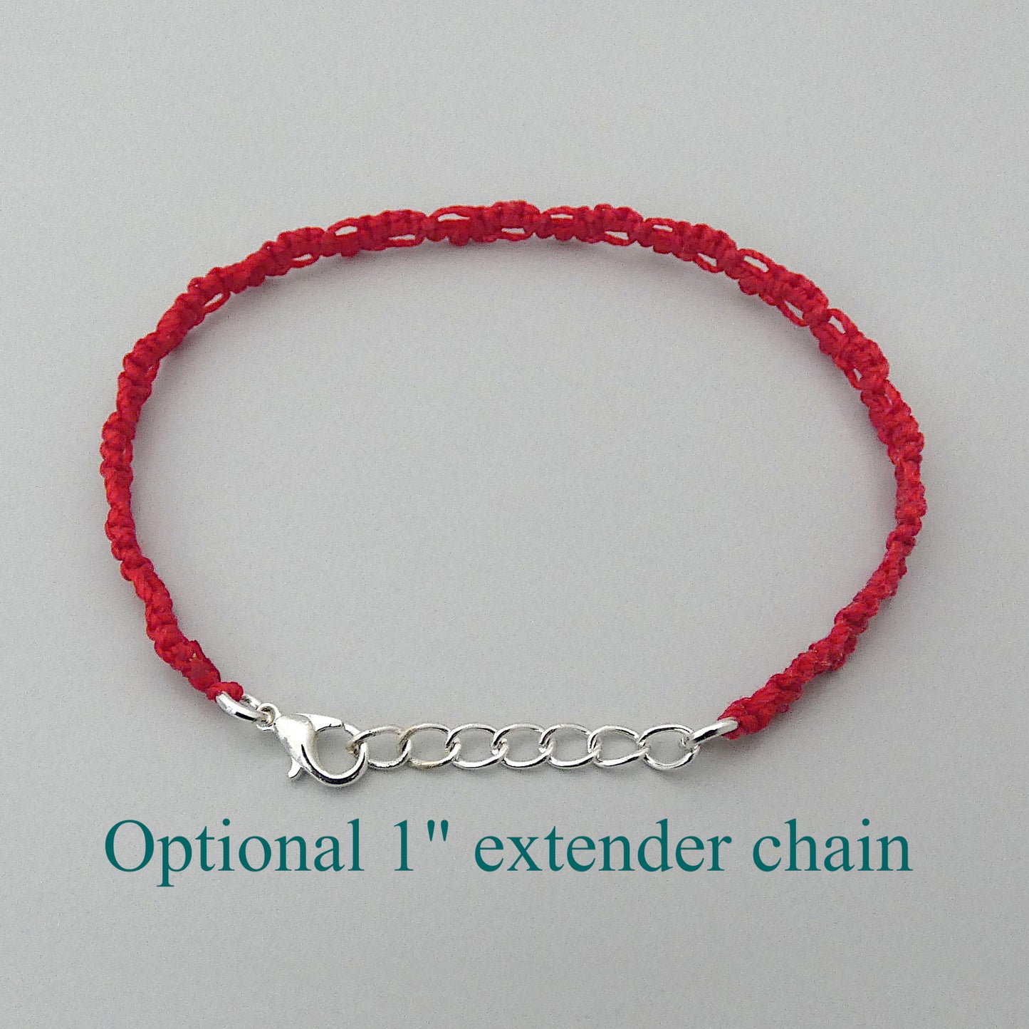Red macramé bracelet tied with an intricate lace effect with silver plated clasp and optional 1” extender chain.