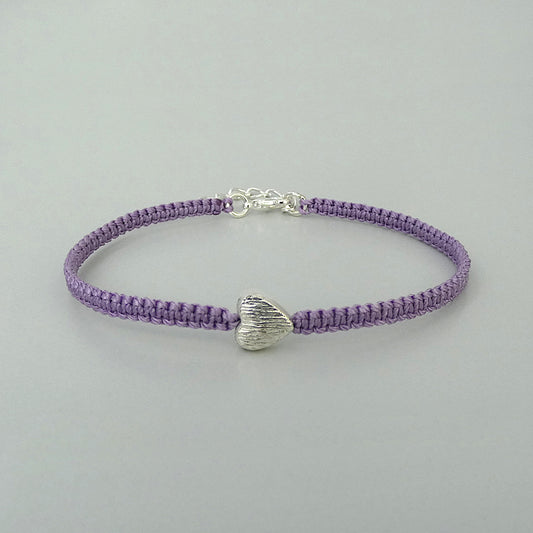 Orchid purple seven inch macramé bracelet with silver plated textured heart charm, lobster clasp and one inch extender chain.