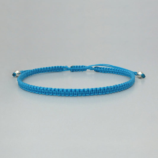 7” adjustable Bermuda blue macramé bracelet for adults with silver plated bead ends.