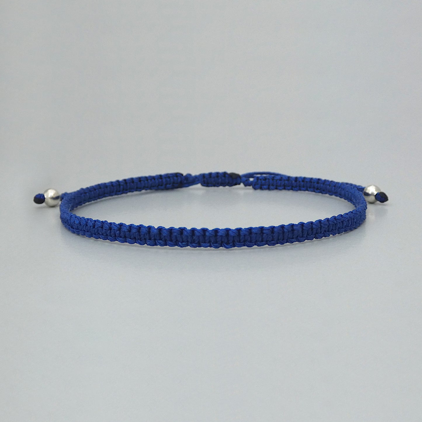 7” adjustable Royal blue coloured macramé bracelet for adults with silver plated bead ends.
