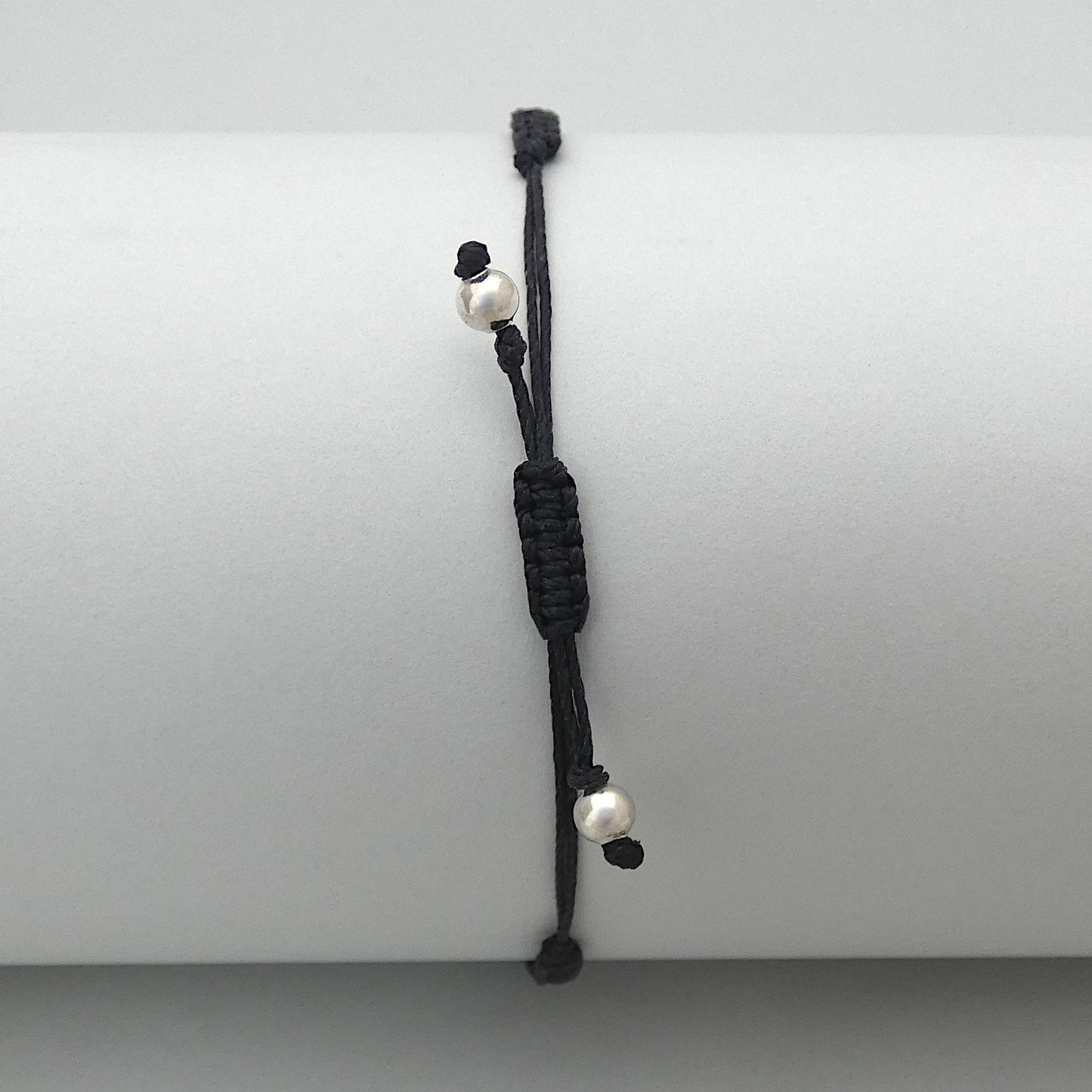 7” adjustable black coloured macramé bracelet for adults with silver plated bead ends.