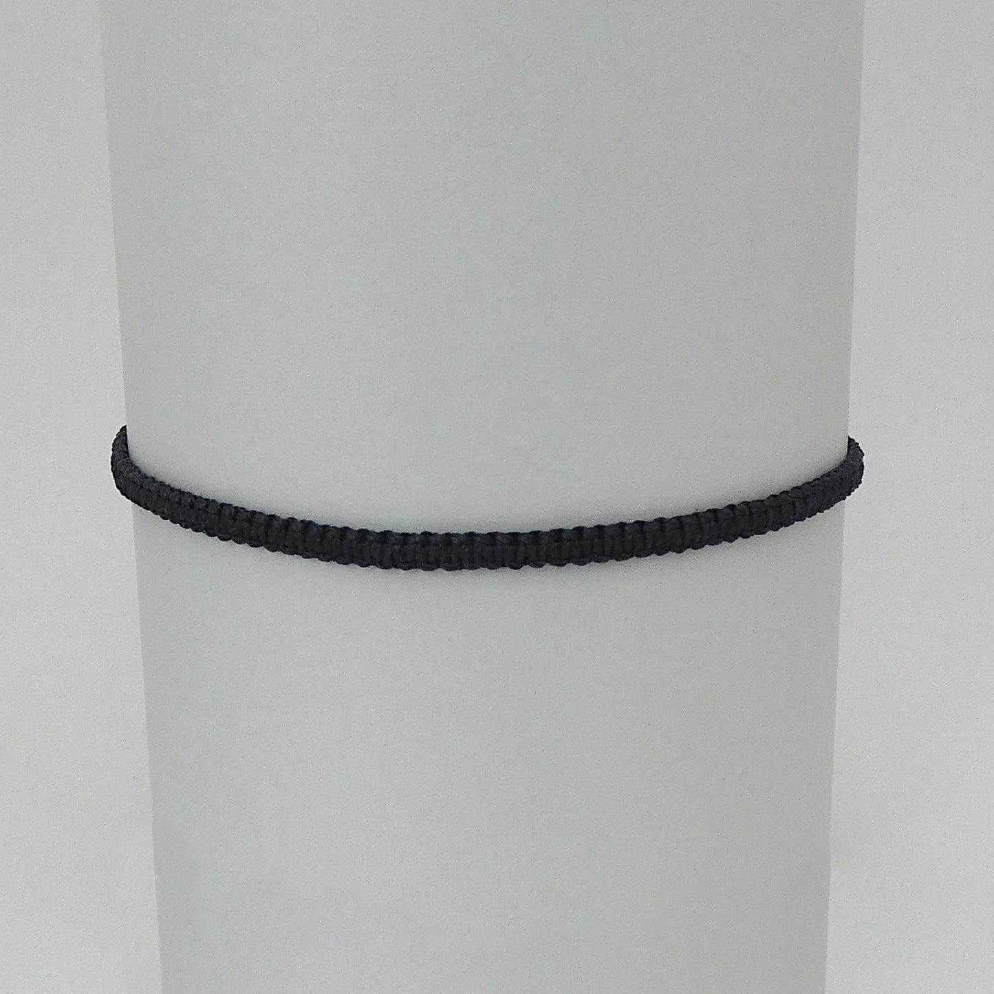 7” adjustable black coloured macramé bracelet for adults with silver plated bead ends.