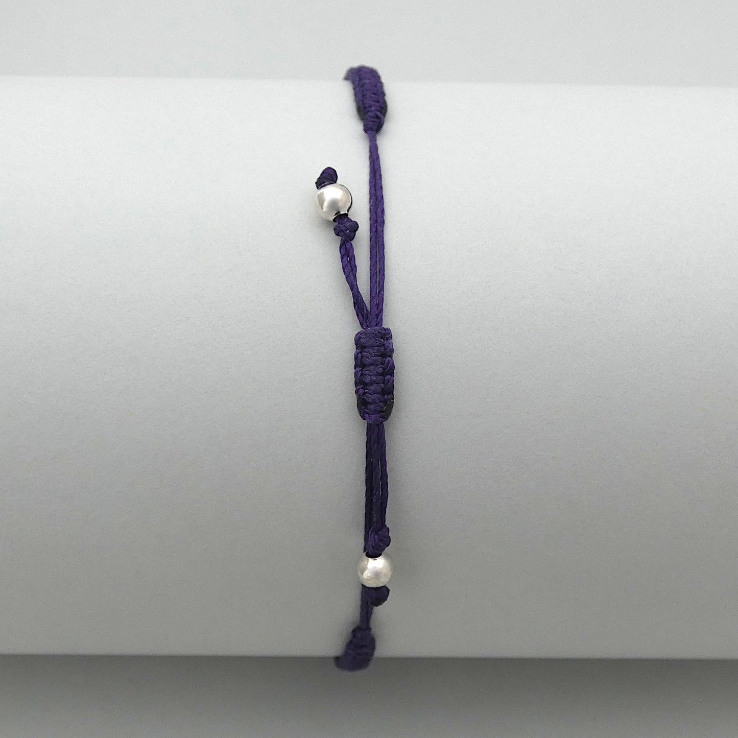 7” adjustable dark purple macramé bracelet for adults with silver plated bead ends.