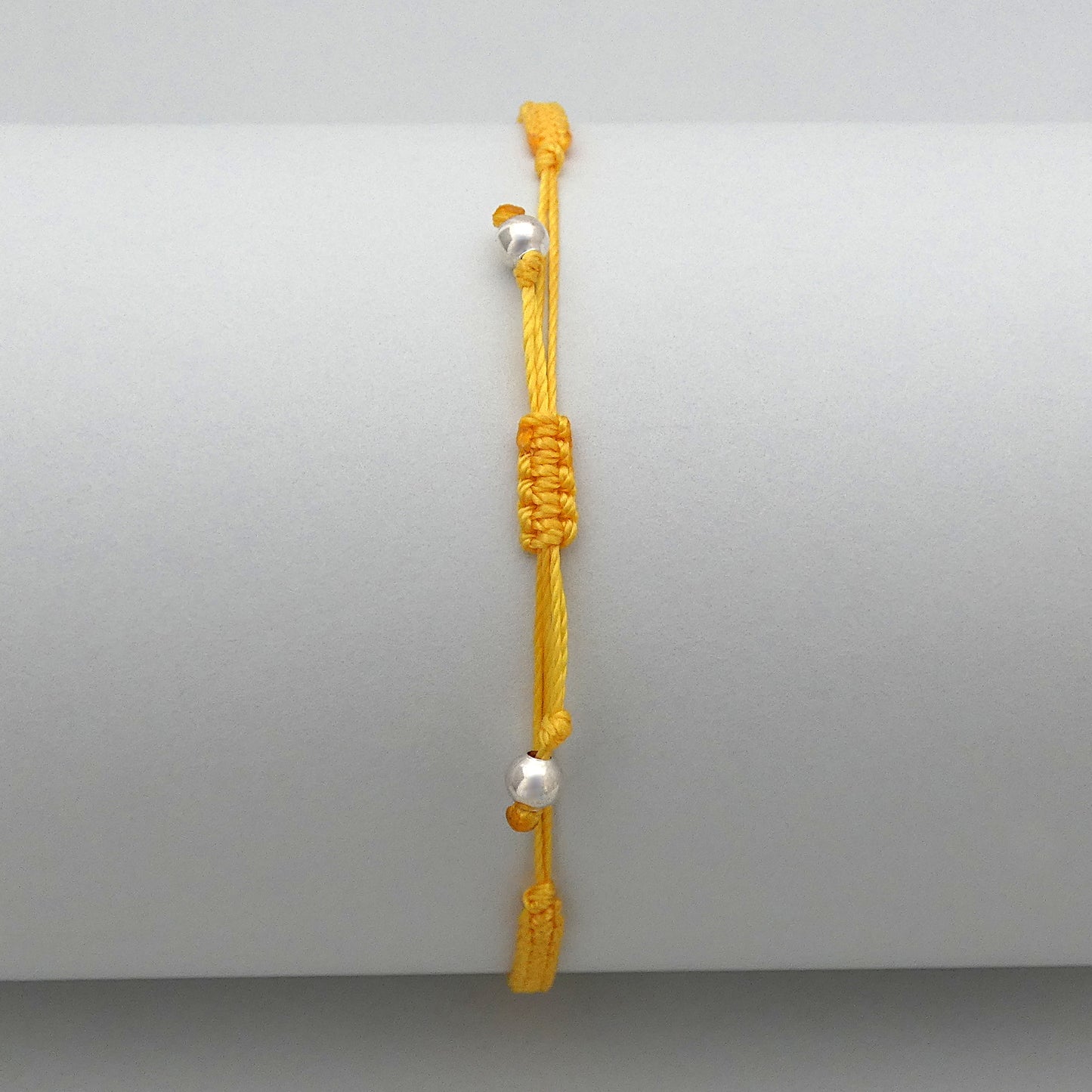 7” adjustable Golden yellow macramé bracelet for adults with silver plated bead ends.