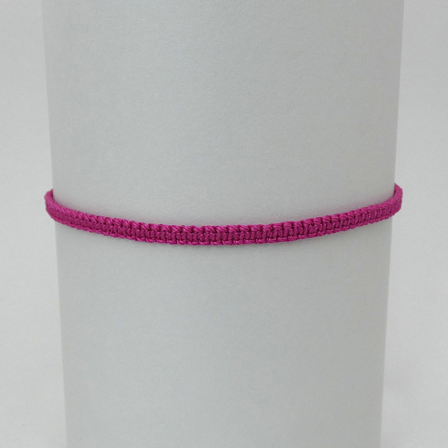 7” adjustable magenta macramé bracelet for adults with silver plated bead ends.
