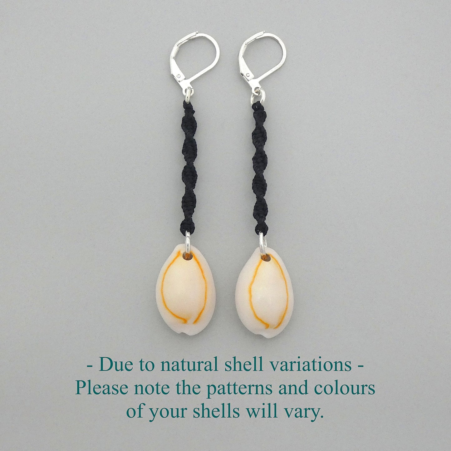 Silver plated leverback earrings with cowrie shells and black macramé twist detail.
