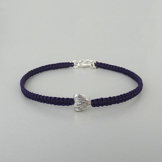 Dark purple seven inch macramé bracelet with silver plated textured heart charm, lobster clasp and one inch extender chain.