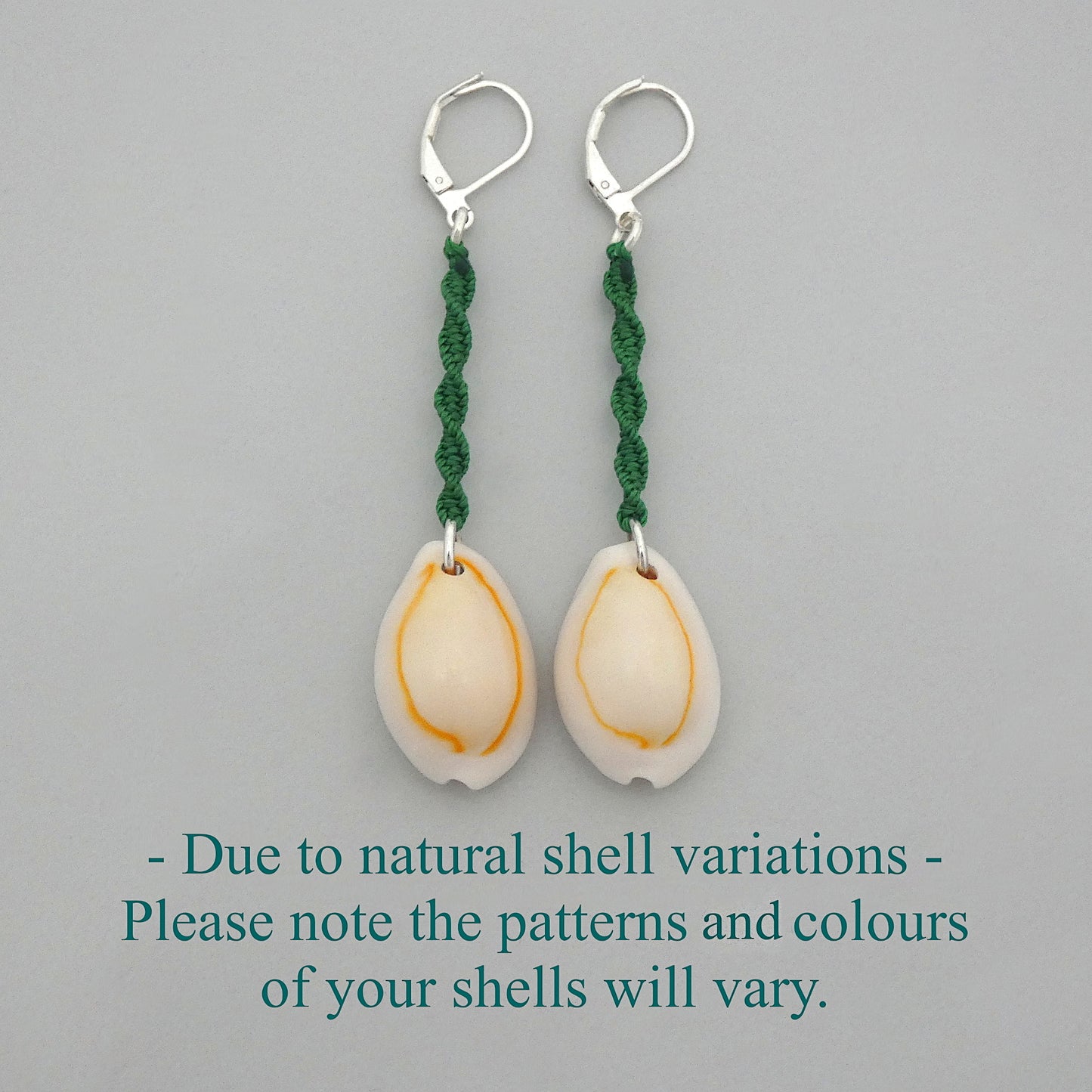 Silver plated leverback earrings with cowrie shells and green macramé twist detail.