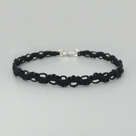 Black macramé bracelet tied with an intricate lace effect with silver plated clasp and optional 1” extender chain.