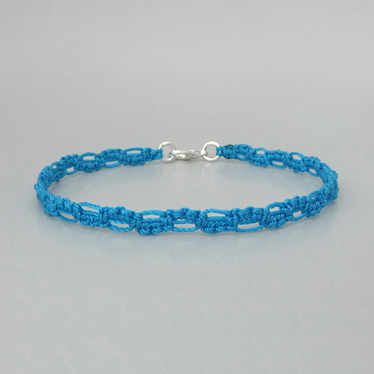Bermuda blue macramé bracelet tied with an intricate lace effect with silver plated clasp and optional 1” extender chain.