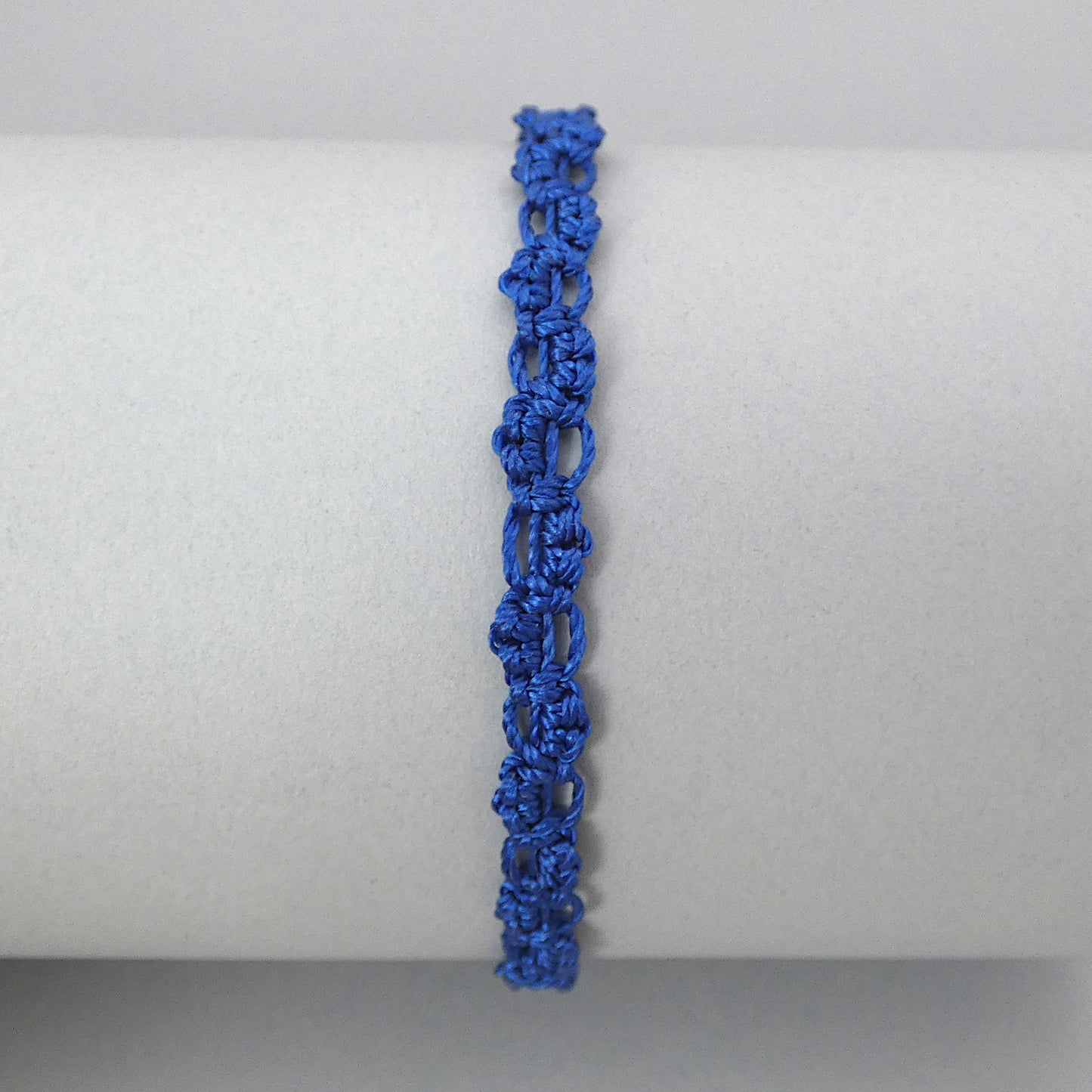 Royal blue macramé bracelet tied with an intricate lace effect with silver plated clasp and optional 1” extender chain.
