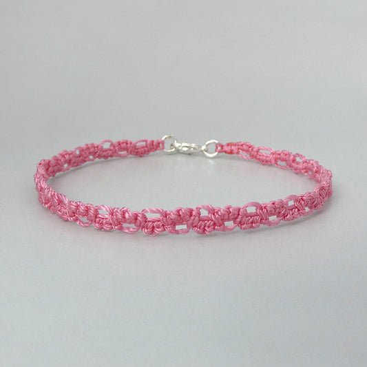 Pink macramé bracelet tied with an intricate lace effect with silver plated clasp and optional 1” extender chain.