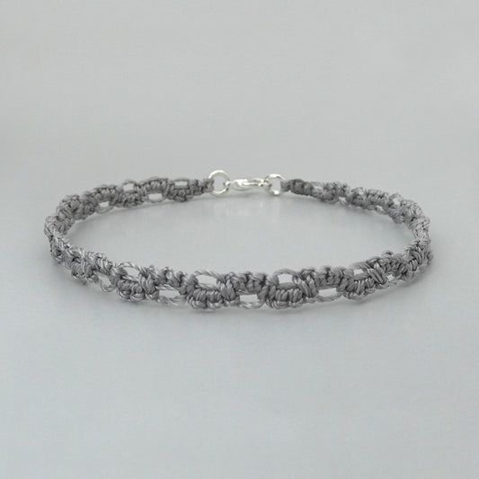 Silver grey macramé bracelet tied with an intricate lace effect with silver plated clasp and optional 1” extender chain.