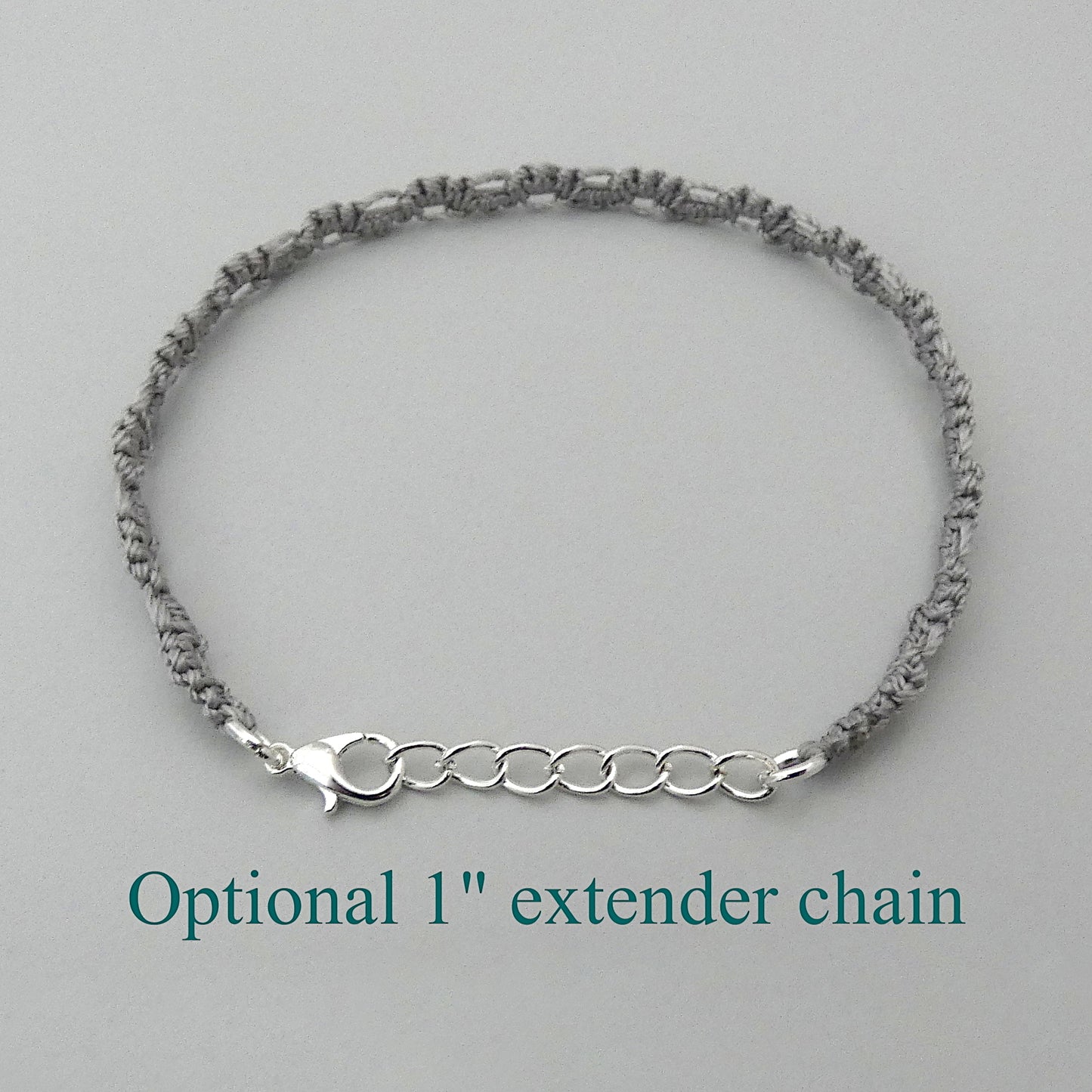 Silver grey macramé bracelet tied with an intricate lace effect with silver plated clasp and optional 1” extender chain.