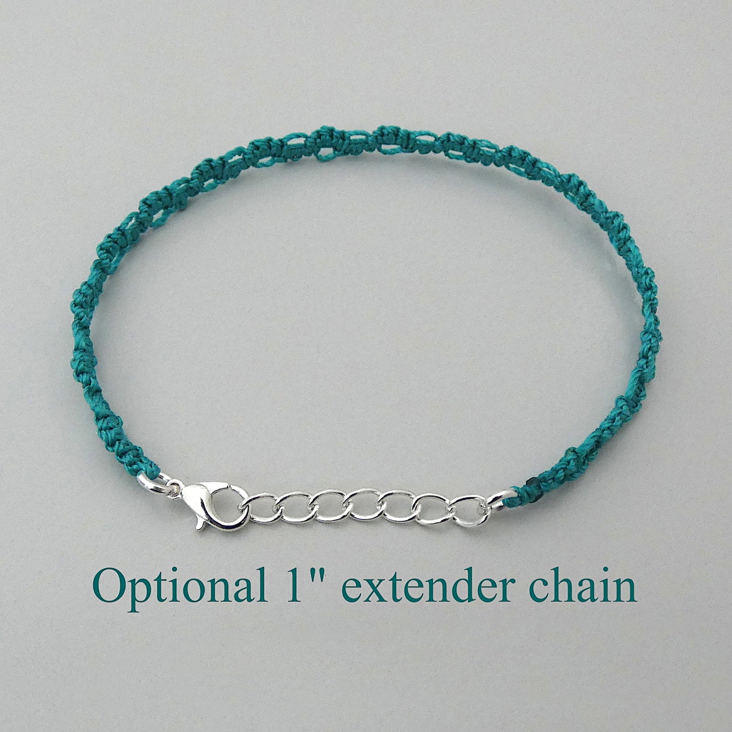 Teal green macramé bracelet tied with an intricate lace effect with silver plated clasp and optional 1” extender chain.