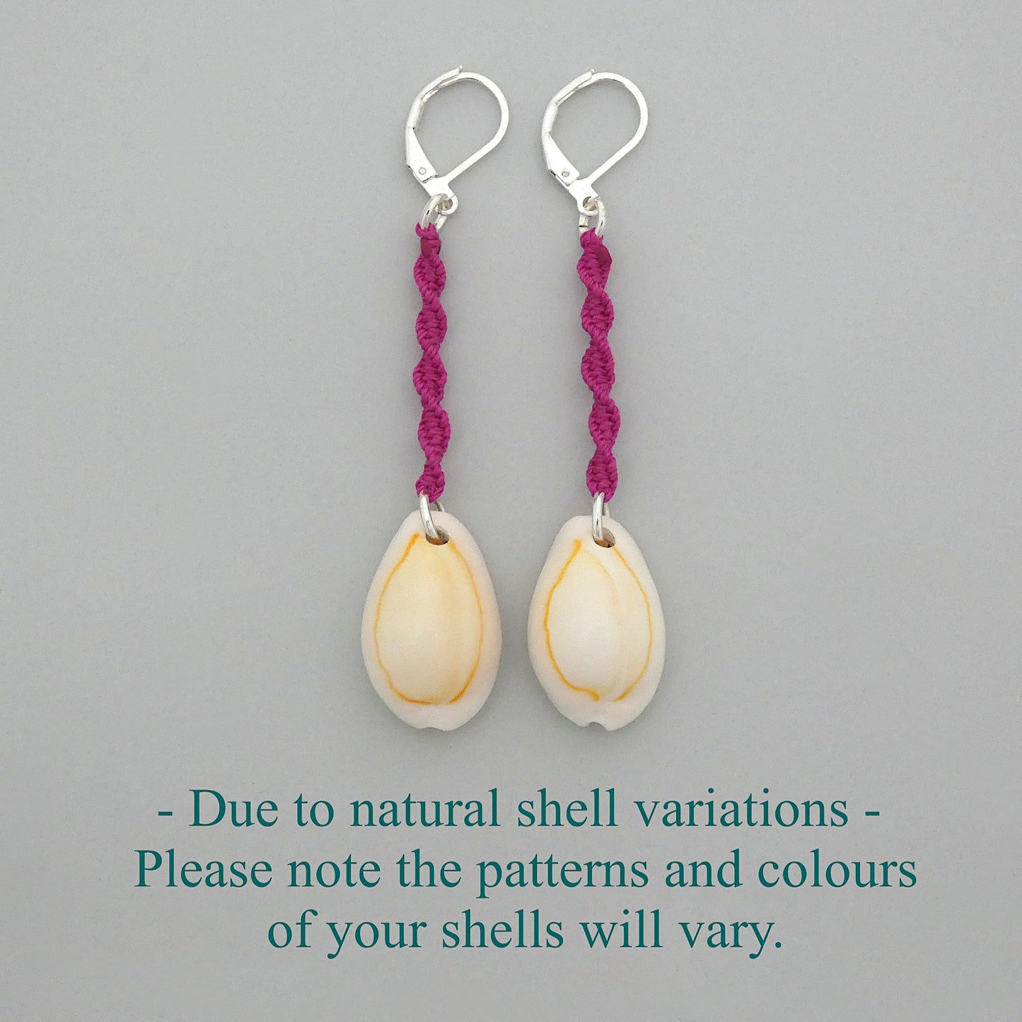 Silver plated leverback earrings with cowrie shells and magenta macramé twist detail.