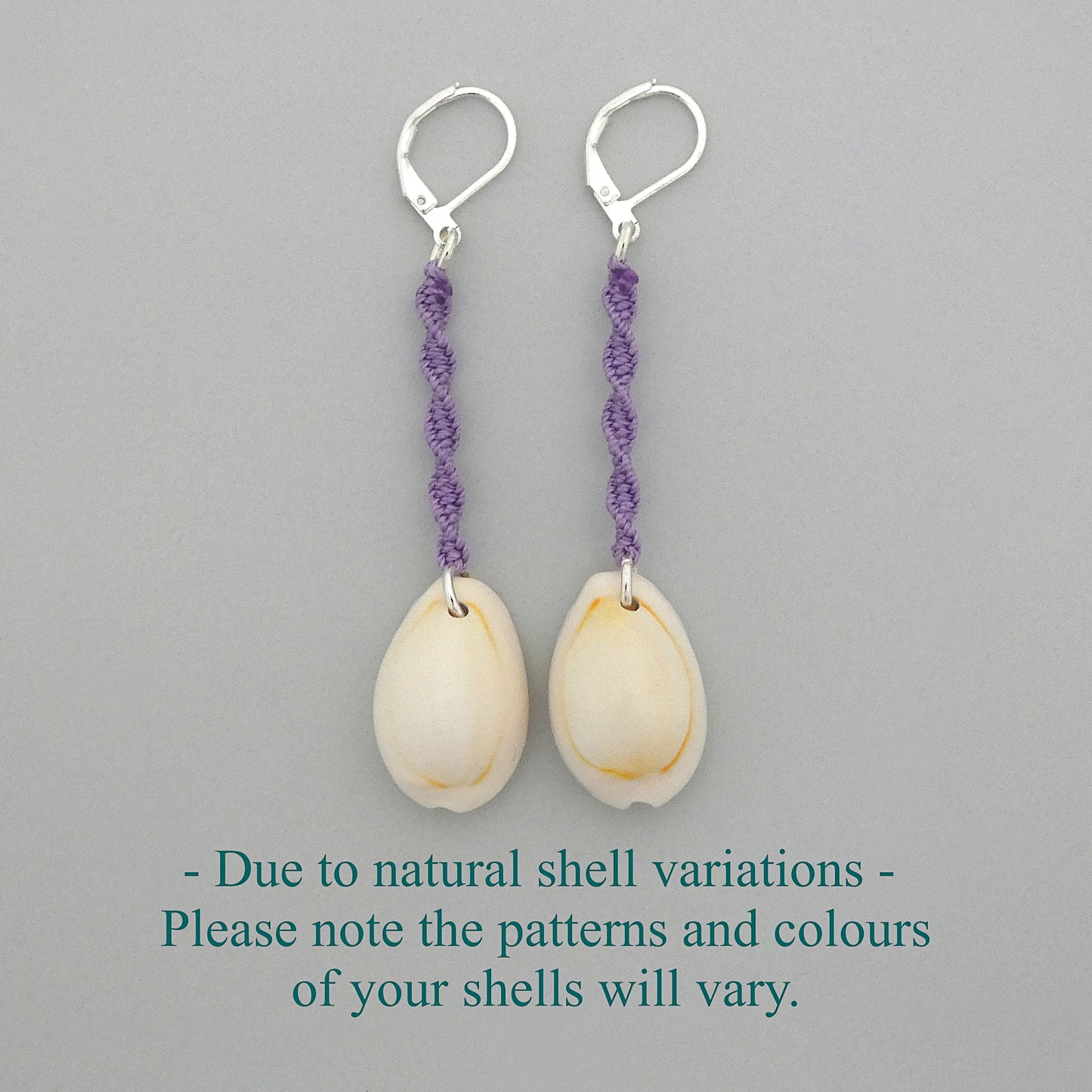 Silver plated leverback earrings with cowrie shells and orchid purple macramé twist detail.