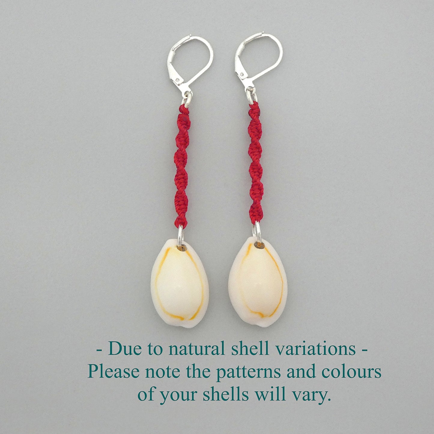 Silver plated leverback earrings with cowrie shells and bright red macramé twist detail.
